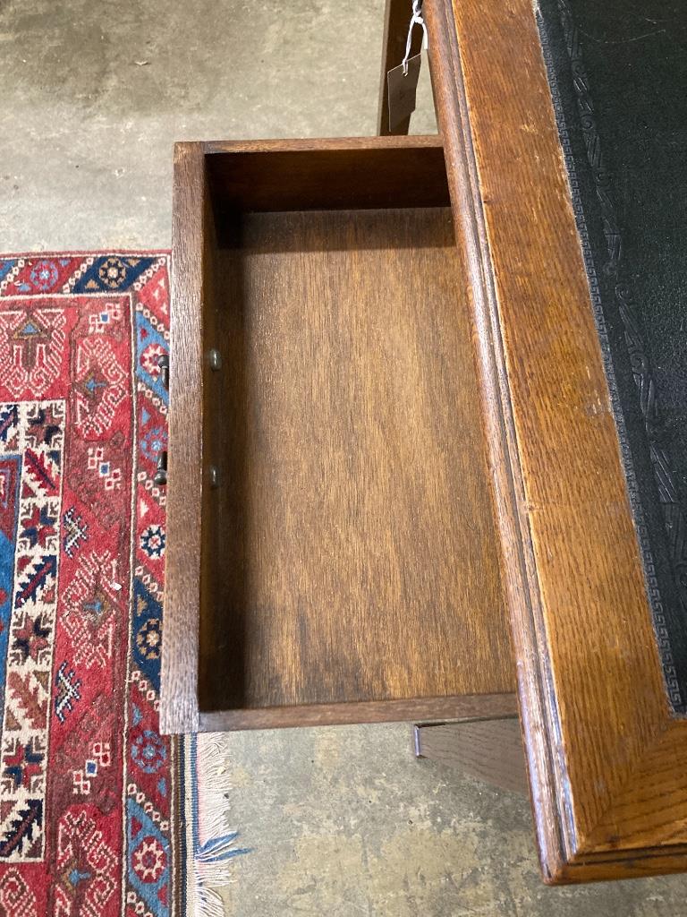 A 1920's oak writing table, width 91cm, depth 60cm, height 76cm